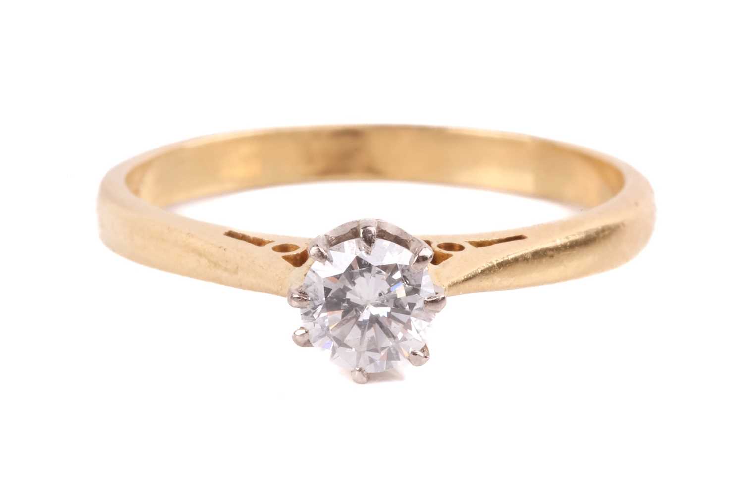 Lot 144 - A diamond solitaire ring set with a round...