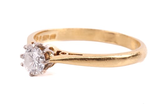 Lot 144 - A diamond solitaire ring set with a round...