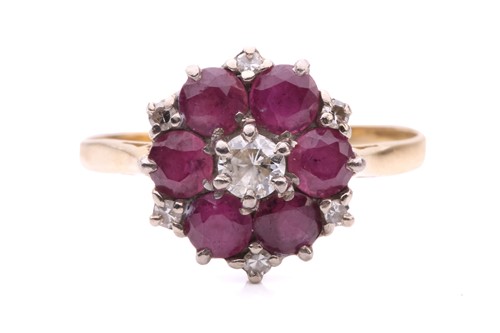 Lot 174 - A ruby and diamond cluster ring, set with a...