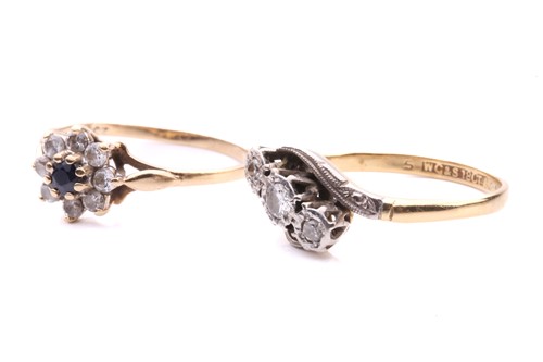 Lot 248 - A three stone diamond cross over ring, with a...