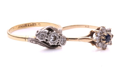 Lot 248 - A three stone diamond cross over ring, with a...