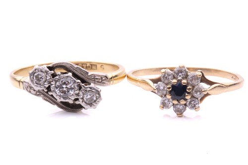 Lot 248 - A three stone diamond cross over ring, with a...