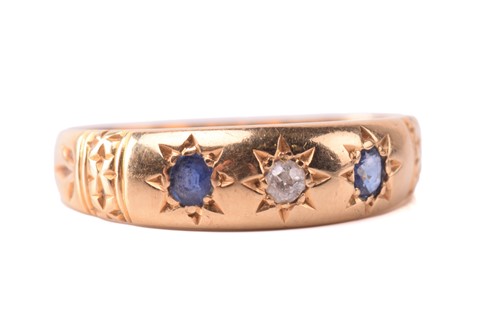 Lot 104 - A sapphire and diamond three-stone gypsy ring...