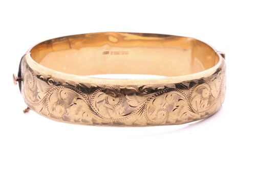 Lot 86 - A 9ct yellow gold hinged bangle, half of the...