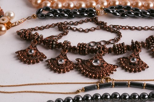 Lot 180 - A Hermatite pearl and gold plated bead...