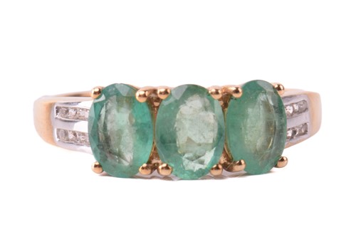 Lot 164 - An emerald and diamond three stone ring, set...