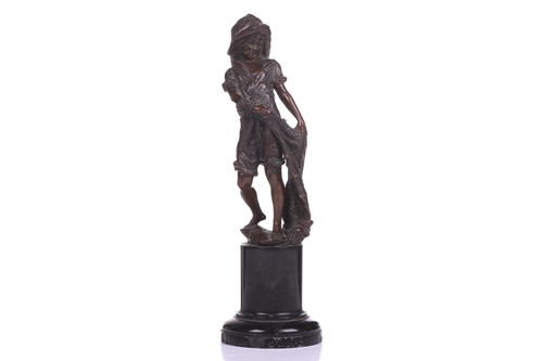 Lot 418 - A bronze figure of a young boy with a fishing...