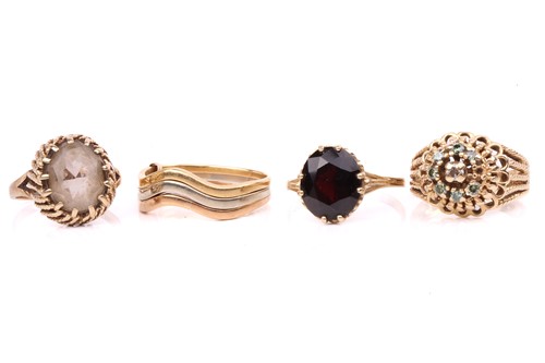 Lot 45 - Three gem-set rings and a trinity ring;...