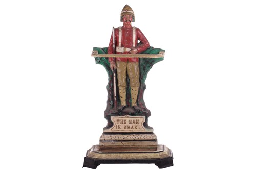 Lot 428 - A cast iron stick and umbrella stand, 'The Man...