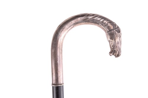 Lot 537 - An ebonised walking stick with white metal...