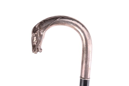 Lot 537 - An ebonised walking stick with white metal...