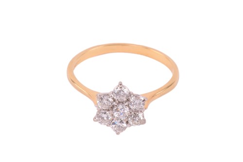 Lot 244 - A diamond daisy cluster ring set with round...