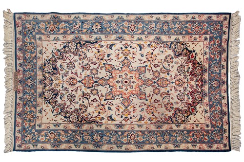 Lot 369 - An ivory ground Isfahan rug, with central star...