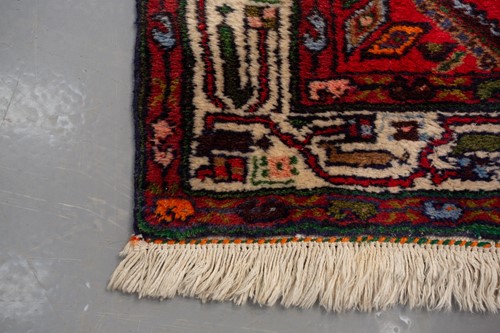 Lot 366 - A Hamadan red ground strip runner, with nine...