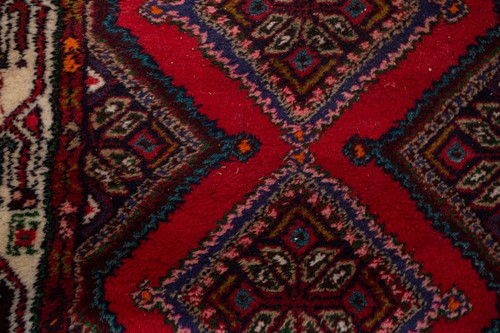 Lot 366 - A Hamadan red ground strip runner, with nine...
