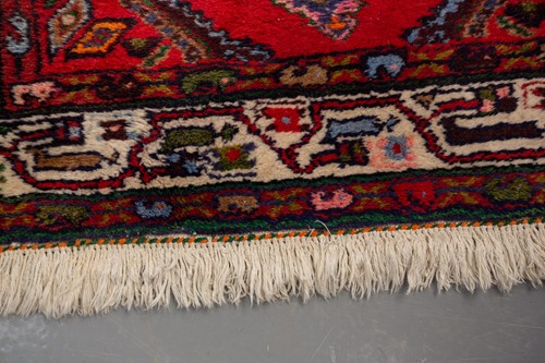 Lot 366 - A Hamadan red ground strip runner, with nine...