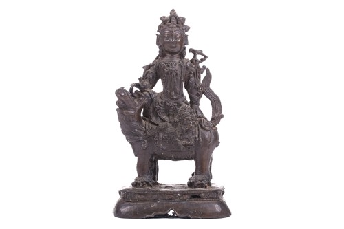 Lot 301 - A bronze figure of Bodhisattva Manjushri on a...