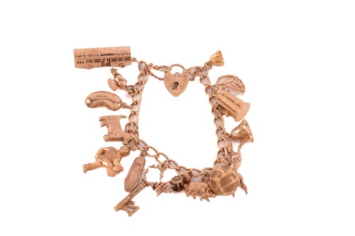 Lot 131 - A 9ct yellow gold charm bracelet with a...