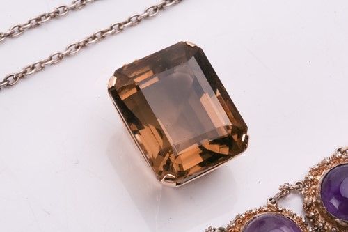 Lot 44 - A smokey quartz pendant, the emerald cut...