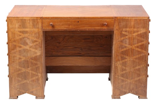 Lot 41 - An Arts and Crafts style walnut desk, one long...