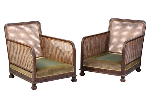 Lot 44 - A pair of 1920s oak cane back bergere...