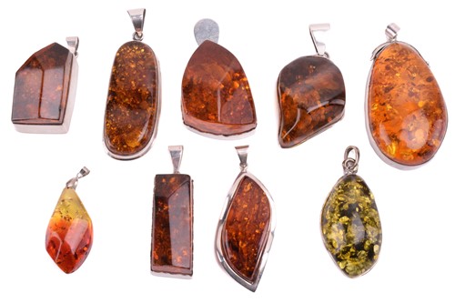 Lot 209 - Seven large treated amber pendants in various...