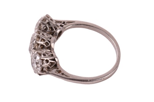 Lot 59 - A three-stone diamond half-hoop ring,...