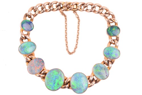 Lot 187 - An opal bracelet in 9ct gold, comprising eight...