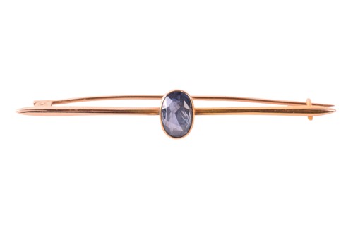 Lot 50 - A sapphire-set bar brooch, collet-set with an...