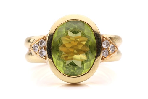 Lot 54 - A peridot and diamond dress ring, collet-set...