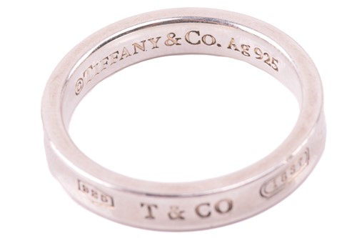 Lot 148 - Tiffany & Co. - a narrow 1837 ring, with...