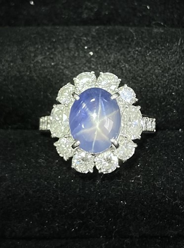 Lot 158 - A star sapphire and diamond entourage ring,...