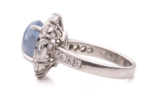 Lot 158 - A star sapphire and diamond entourage ring,...