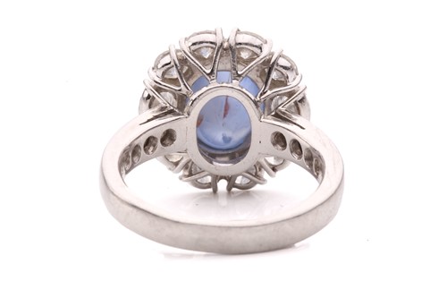 Lot 158 - A star sapphire and diamond entourage ring,...