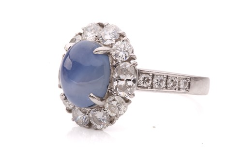 Lot 158 - A star sapphire and diamond entourage ring,...