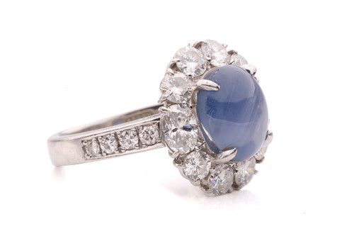 Lot 158 - A star sapphire and diamond entourage ring,...