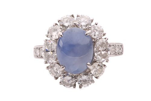 Lot 158 - A star sapphire and diamond entourage ring,...