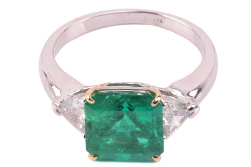 Lot 6 - A vivid emerald and diamond three-stone ring,...