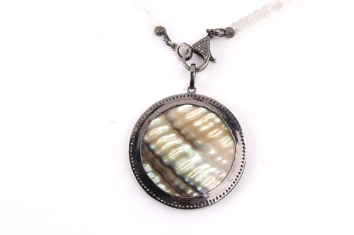 Lot 49 - A diamond and mother of pearl pendant, the...