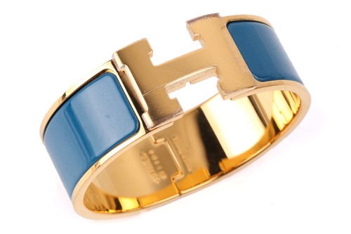 Lot 70 - Hermès - A wide 'Clic H' bracelet with teal...