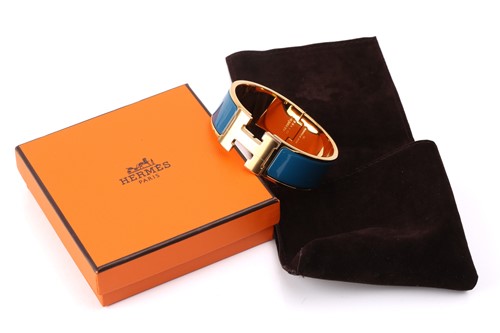 Lot 70 - Hermès - A wide 'Clic H' bracelet with teal...
