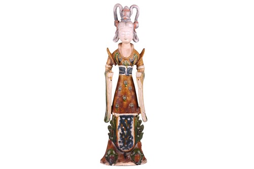 Lot 123 - A Chinese sancai glazed pottery standing court...