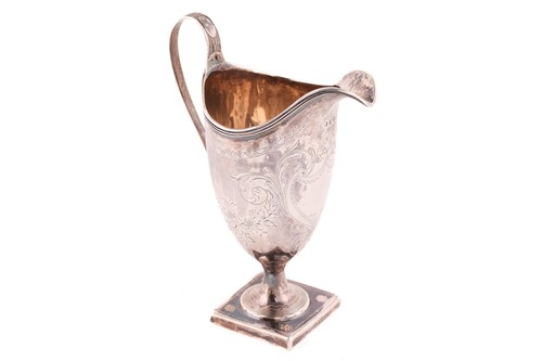 Lot 511 - A George III silver helmet cream jug, by the...