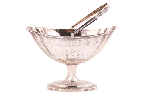 Lot 494 - A George III Irish silver swing-handled sugar...