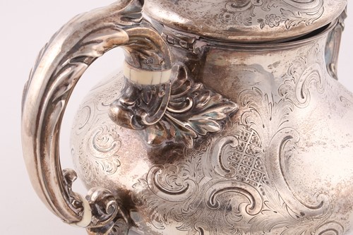 Lot 489 - A Victorian Rococo style silver teapot, by...
