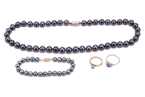 Lot 130 - Two gem set rings, a Tahitian pearl necklace...