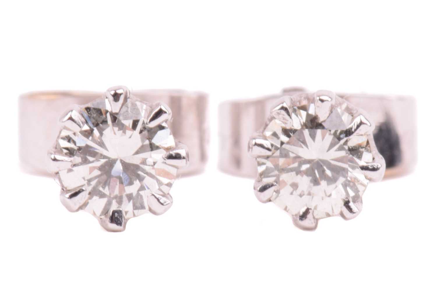 Lot 138 - A pair of diamond stud earrings in 9ct white...