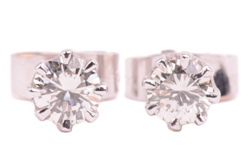 Lot 138 - A pair of diamond stud earrings in 9ct white...