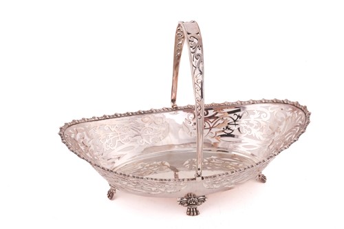 Lot 513 - A silver pierced basket with swing handle,...