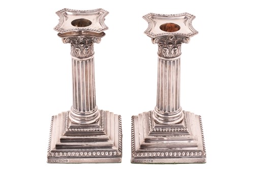 Lot 438 - A pair of Corinthian column candlesticks,...